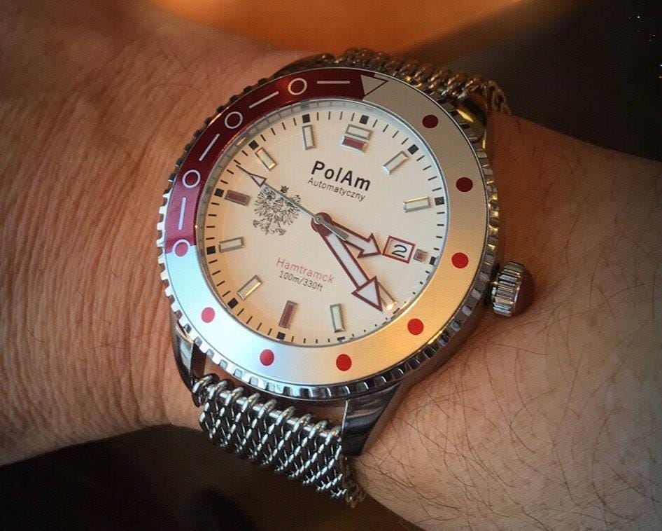 PolAm Hamtramck on wrist with shark mesh bracelet, warm lighting